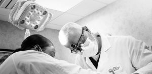 An oral surgeon and assistant performing a procedure
